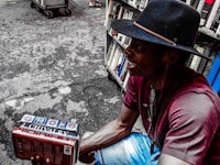 a man in a hat holding a book